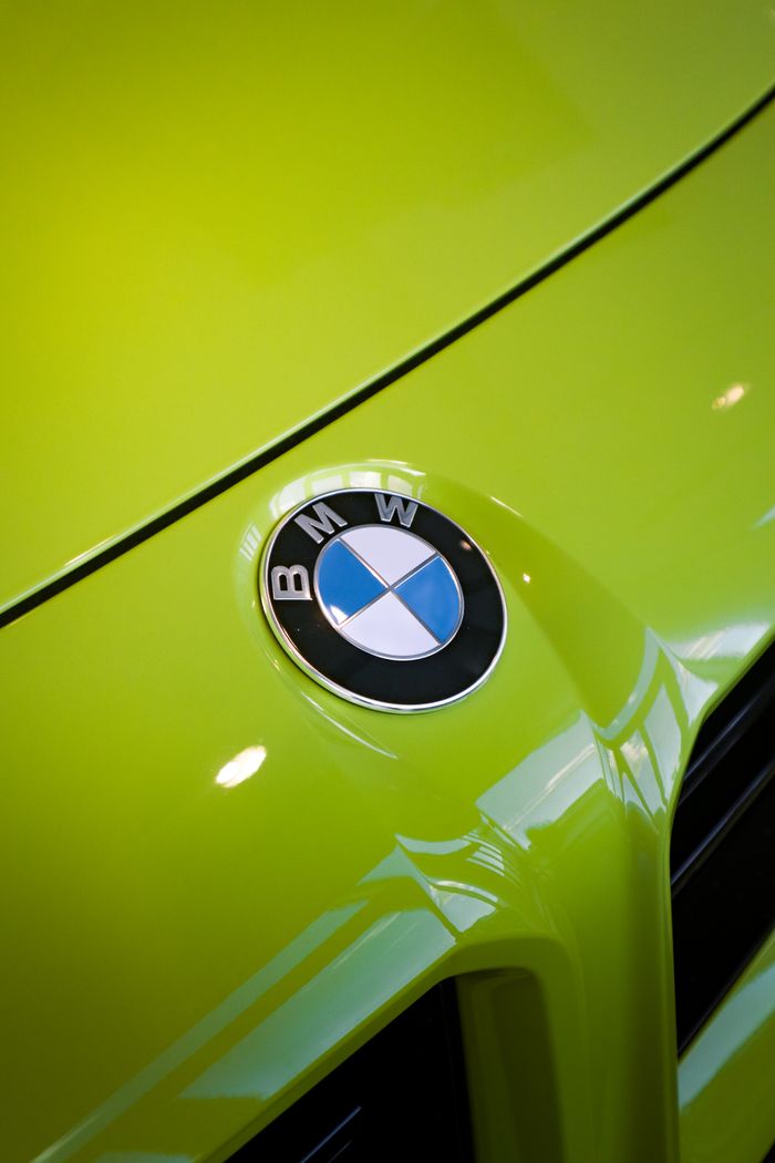 The Art of Drawing Readers In: Your attractive post title goes here Detailed shot of lime green car showcasing the BMW emblem. Modern design and vivid color.